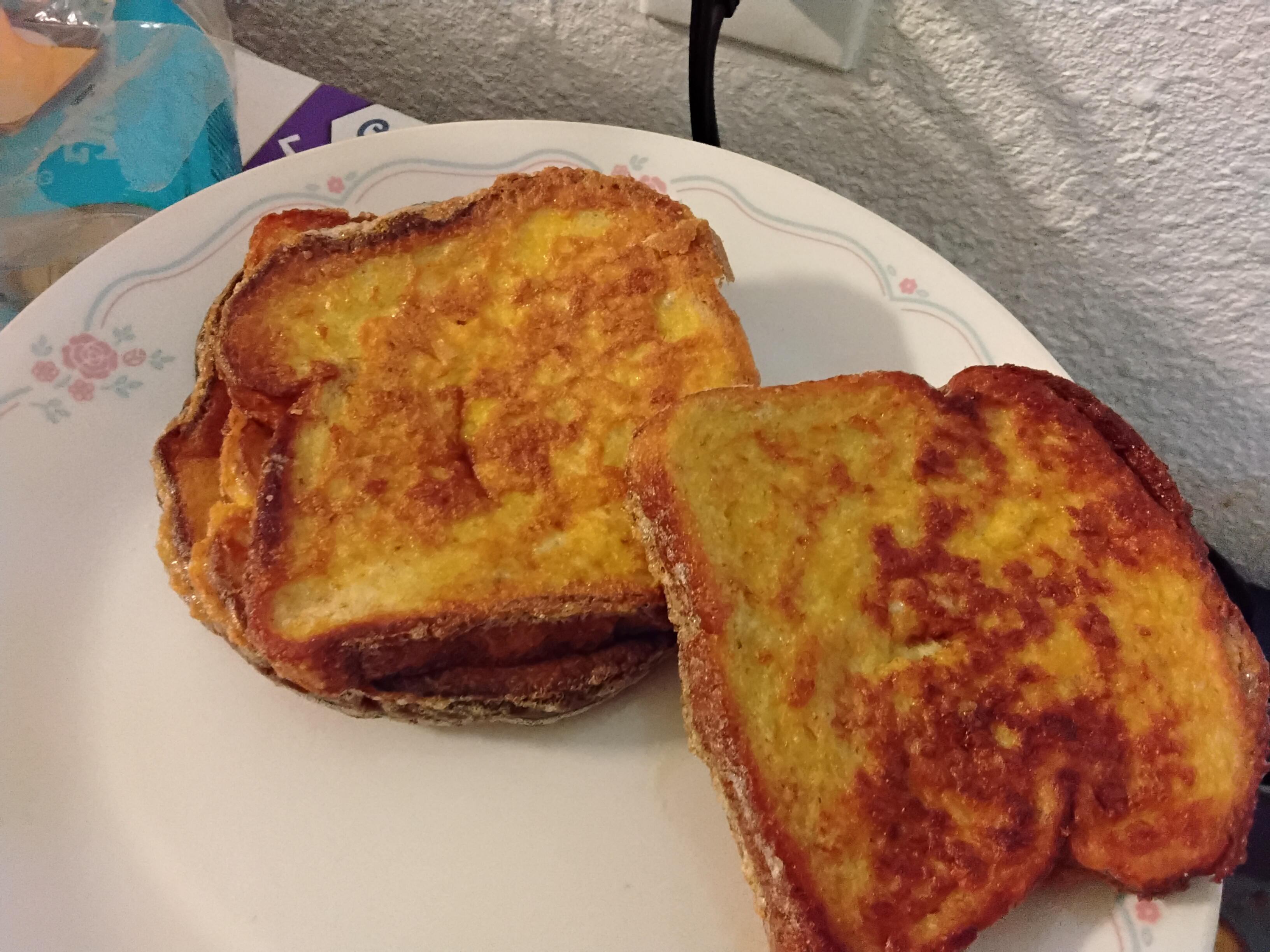 Two slices of golden French toast, deeply caramelized custard exterior