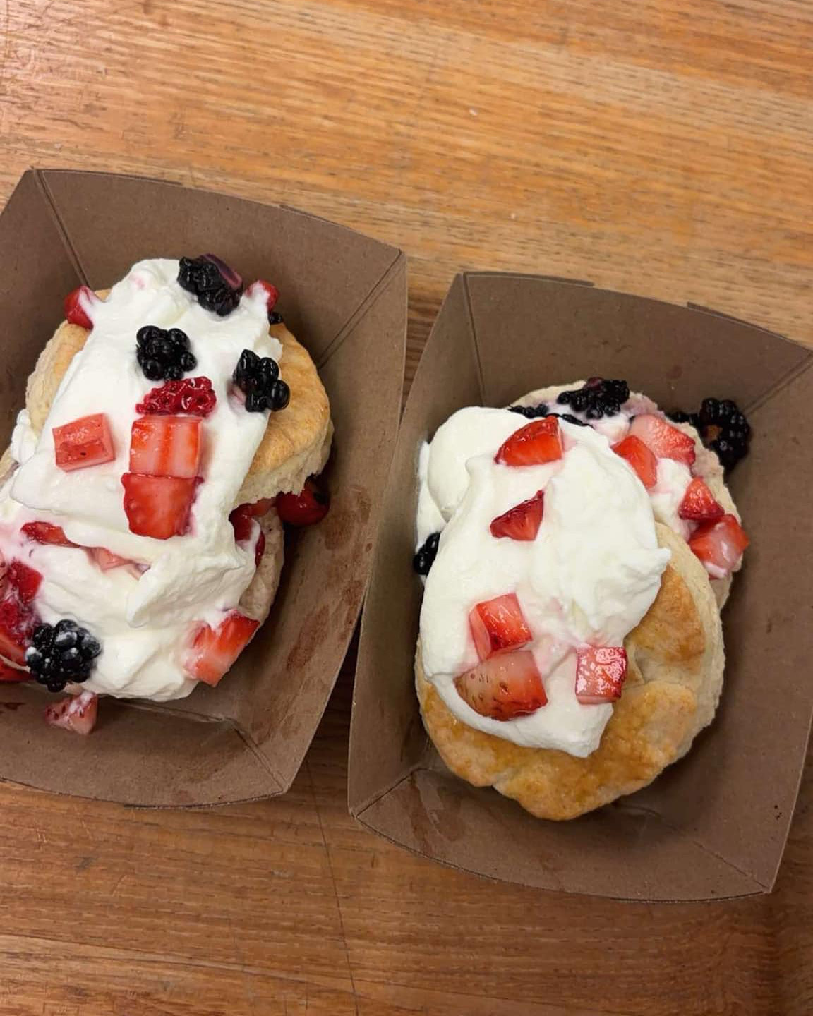 Strawberry shortcakes with whipped cream, fresh strawberries and blackberries
